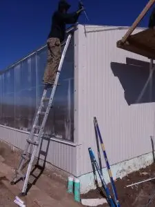 worker installing greenhouse